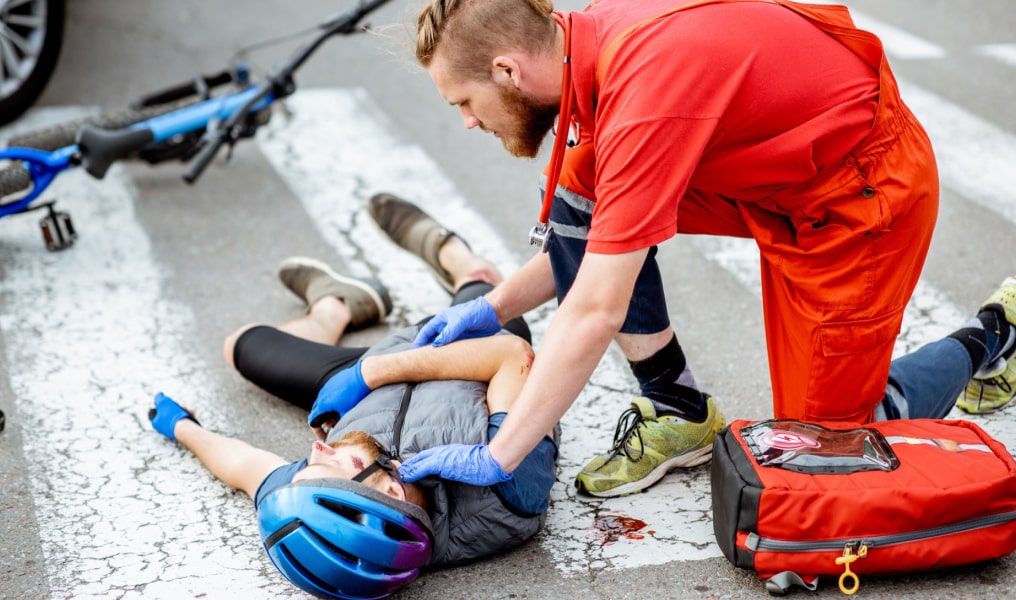 Medical Expert Helping Cyclist