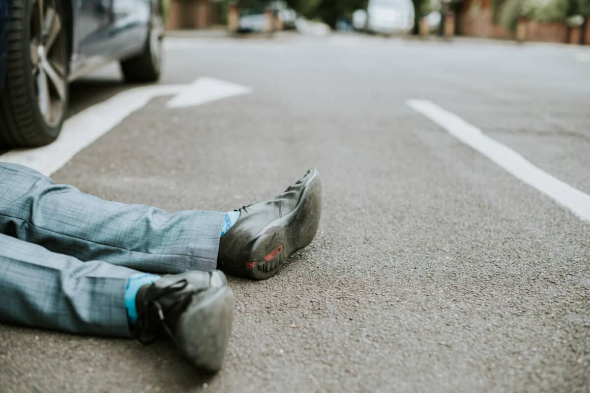 Person Lying on the Ground After Car Accident