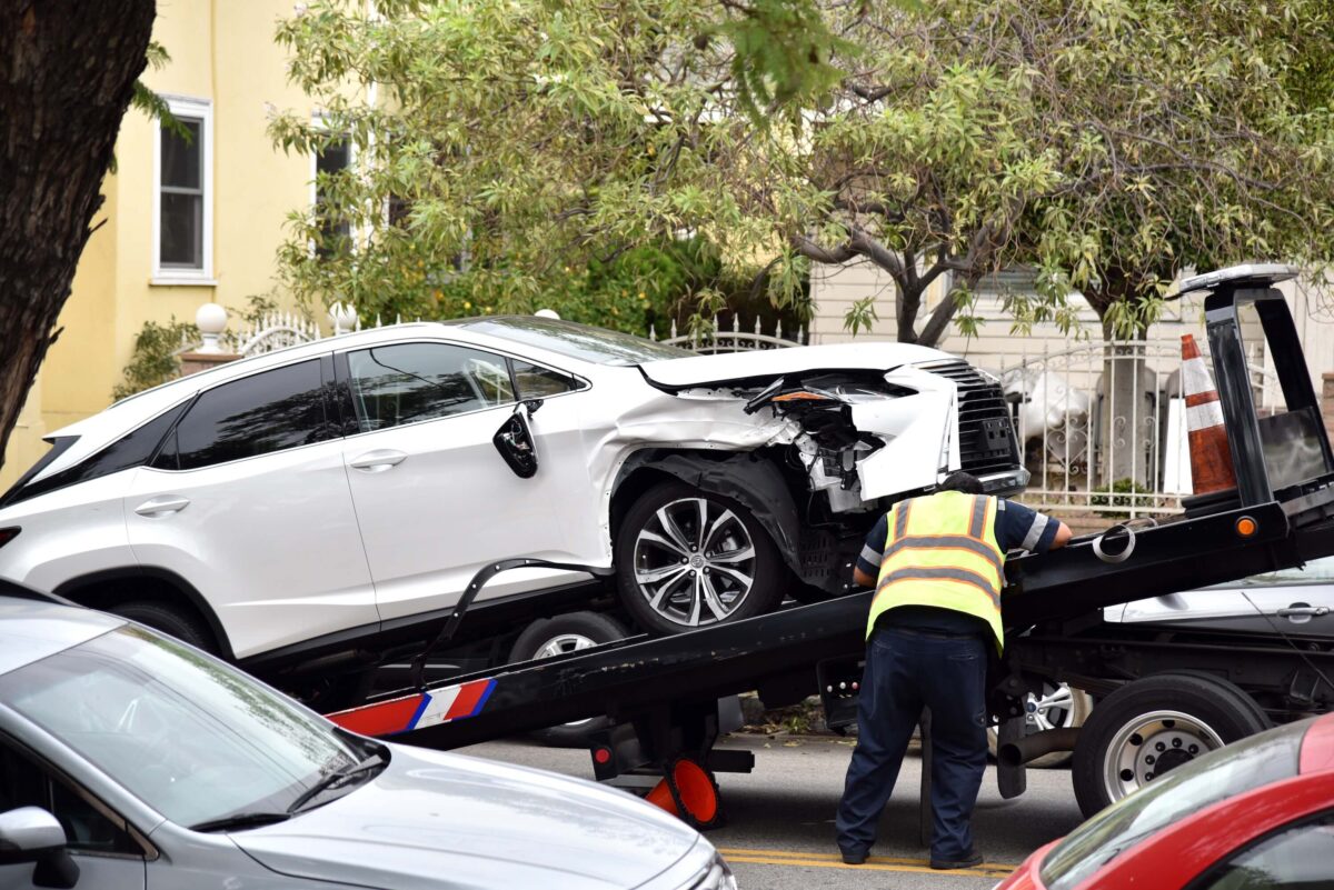 Wrecked car A tow truck driver loading a wrecked car onto a tow truck