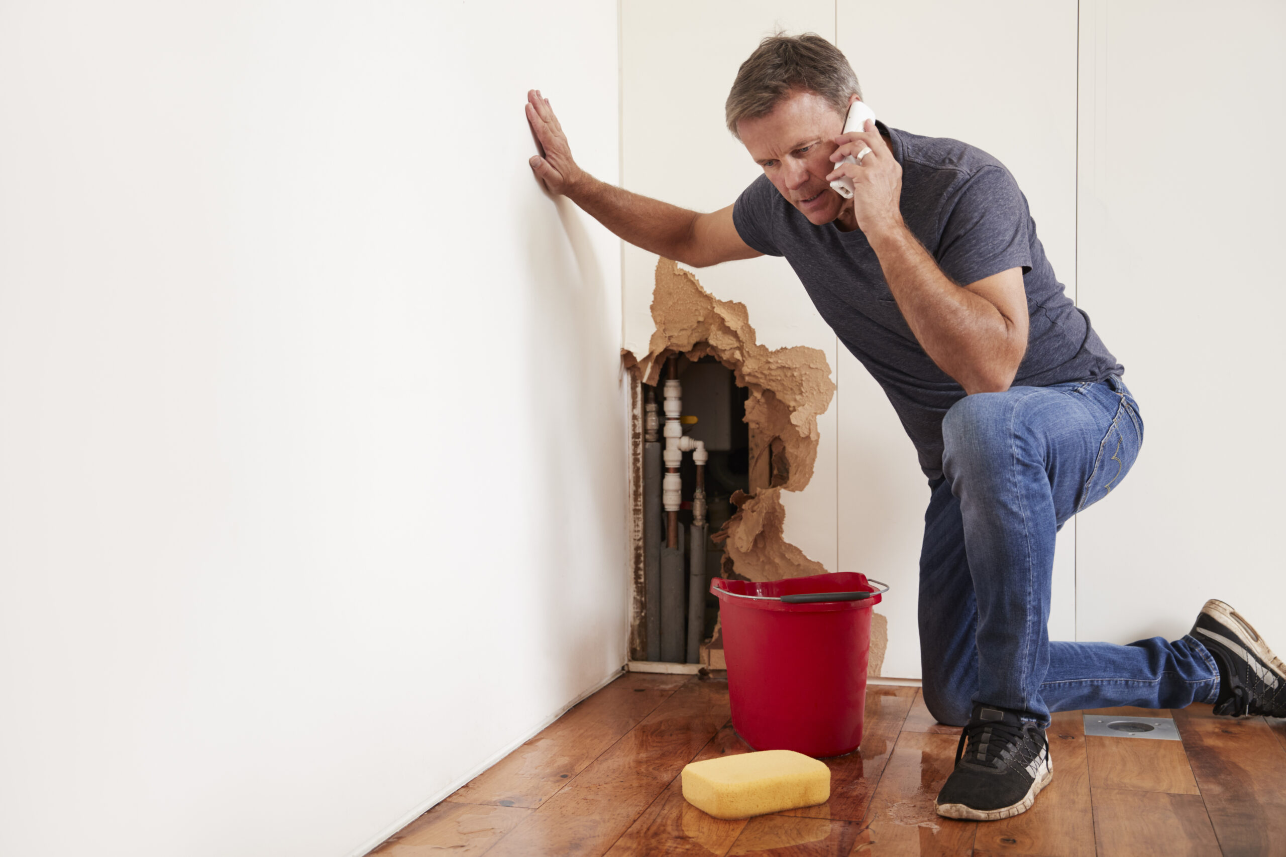 Man calling a Plumbing Leak Pipe Burst Lawyer for help after a home water pipe burst