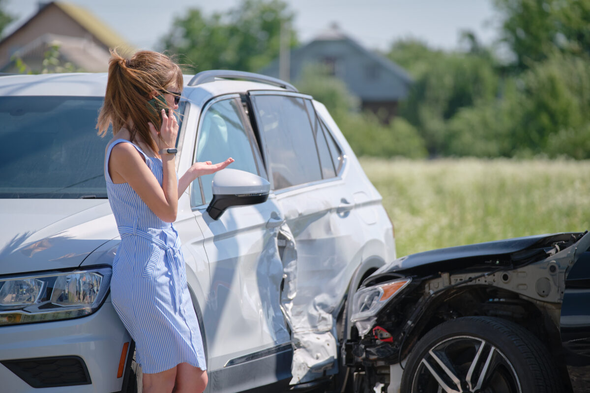 Woman in a car crahs calling a car accident lawyer